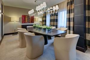 a dining room with a table and chairs at Hilton Frankfurt Airport in Frankfurt/Main