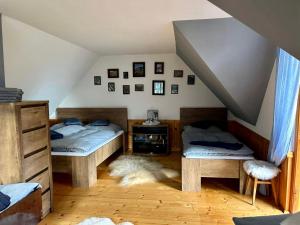 a room with two beds in a attic at Domek pod Modrzewiem in Nowy Targ