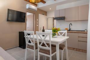 a kitchen with a white table and chairs at AAA Apartments & Rooms with FREE parking in Pula