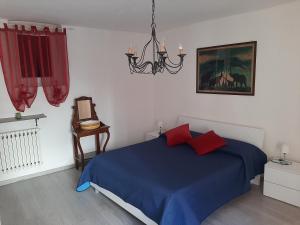 House Vittone Venaria Reale في فيناريا ريالي: غرفة نوم بسرير ازرق وثريا