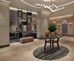 a lobby with a table and a dining room at Hilton Milan in Milan