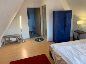 a bedroom with a bed with a blue curtain in it at Ferienhaus in Lassan vor Usedom in Lassan