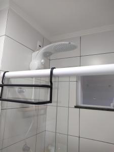 a bathroom with a shower head and a toilet at Pousada Loft São Chico in São Francisco do Sul