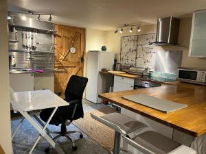 a kitchen with a table and chairs and a refrigerator at Studio Annex in Cottenham