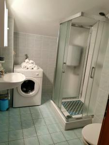 a bathroom with a washing machine and a shower at Apartment Paulina in Trogir