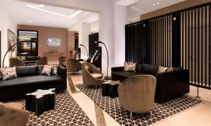 a lobby with couches and chairs in a building at DoubleTree by Hilton Oradea in Oradea