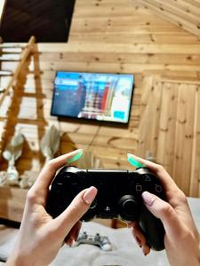 a person holding a camera in a room with a tv at Lawendowy Wypas in Mierzeszyn