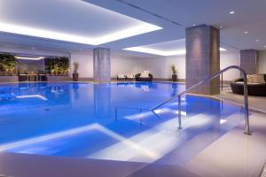 a large swimming pool in a hotel lobby at Hilton Prague Hotel in Prague