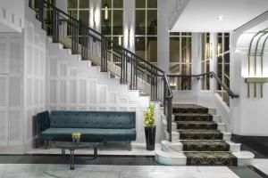 a living room with a green couch and stairs at Hilton Prague Old Town in Prague