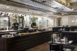 a restaurant with a buffet line with food on display at Hilton Prague Old Town in Prague