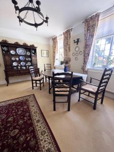 a dining room with a table and chairs at The Courtyard in Newmarket