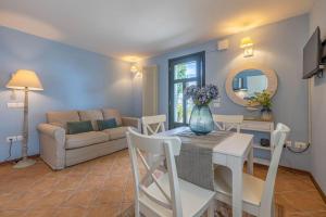 a living room with a table and a couch at Casa Orizzonte - Appartamento con vista in Gabicce Mare