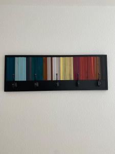a row of colored albums hanging on a wall at Harmony Apartment, your holiday home in Rust with balcony & river-view, 5min to Europa-Park in Rust +24 photos