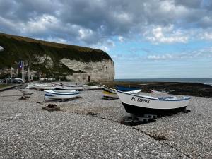a group of boats sitting on a rocky beach at Gîte Adaméo in Yport +9 photos
