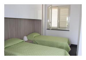 Cama ou camas em um quarto em The Green Seaside
