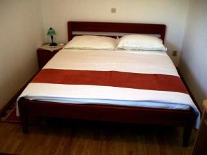 a bedroom with a large bed with two pillows at Apartment Mia in Orebić