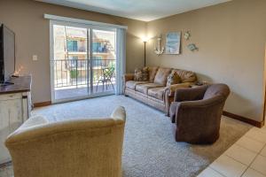 a living room with a couch and two chairs at Cozy Condo with Resort Perks - Half Mi to Beach! in Lake Havasu City