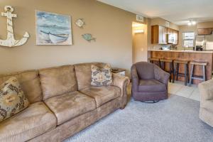 a living room with a couch and a chair at Cozy Condo with Resort Perks - Half Mi to Beach! in Lake Havasu City