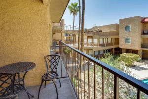 a balcony with a table and chairs and a building at Cozy Condo with Resort Perks - Half Mi to Beach! in Lake Havasu City