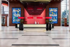 een lobby van een gebouw met schilderijen aan de muren bij Hilton Warsaw City Hotel in Warschau