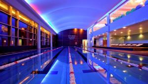 a swimming pool in a building with its lanes at Hilton Warsaw City Hotel in Warsaw