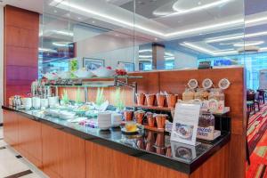 a buffet line with plates and bowls on display at Hilton Warsaw City Hotel in Warsaw