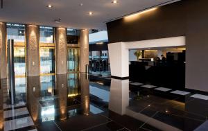 a lobby with a bar in a building at Hilton Madrid Airport in Madrid