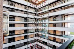 an external view of a building with a glass facade at Hilton Madrid Airport in Madrid