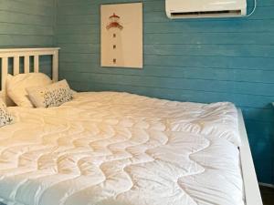 a large white bed in a room with a lighthouse at Holiday home SÖLVESBORG X in Sölvesborg