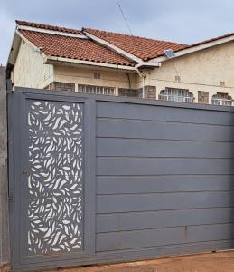 a garage door with a design on it in front of a house at Mfalme House, Ngoingwa Estate, 100 Metres from Thika-Mangu Rd, Close to Thika City Centre - Free Parking, Fast Wi-Fi, Smart TV, 2 Bedrooms Perfect for a Family of 2-4 Members in Thika