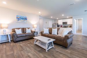a living room with two couches and a coffee table at Coastal Harmony in Foley