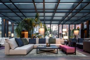 a living room with a couch and a table at Hilton Lake Como in Como