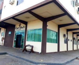 a building with a bench in front of it at Carvalho's Hotel in Palmas