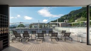 a group of chairs and tables on a balcony at Hilton Lake Como in Como