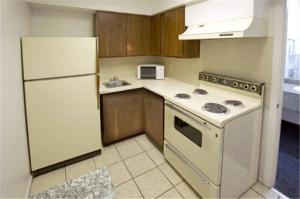 a kitchen with a white stove and a refrigerator at Travelodge by Wyndham New Braunfels in New Braunfels