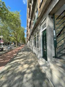 an empty street next to a building at Centraal and on the ground in Rotterdam