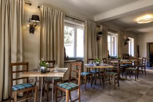 a restaurant with wooden tables and chairs and a window at Aparthotel Claviere in Claviere