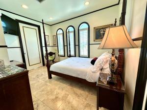 a bedroom with a bed and a table with a lamp at Bliss By The Sea in Saint Augustine