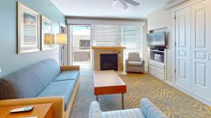 a living room with a blue couch and a fireplace at WorldMark Seaside by BookTimeShares in Seaside