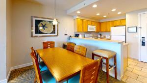 a kitchen with a wooden table and chairs and a counter at WorldMark Seaside by BookTimeShares in Seaside