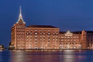 a large building with a clock tower on top of it at Hilton Molino Stucky Venice in Venice