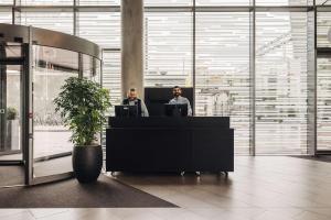 two men sitting at a desk in an office at DoubleTree by Hilton Amsterdam Centraal Station in Amsterdam