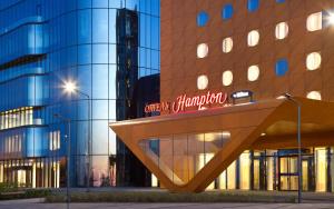 a building with a sign on the side of it at Hampton by Hilton Saint-Petersburg ExpoForum in Saint Petersburg