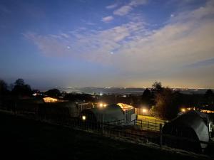 a train yard with a train at night at Acorns Luxury Glamping in Holywell