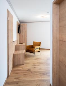 ein Wohnzimmer mit einem Stuhl und einem Tisch in der Unterkunft Moderne Ferienwohnung direkt am Wasser in Heiligenstadt