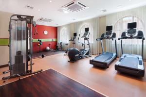 a gym with several treadmills and exercise bikes at Hampton by Hilton Samara in Samara