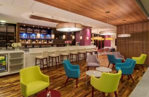 a restaurant with colorful chairs and a bar at Hampton by Hilton Warsaw City Centre in Warsaw