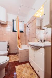 a bathroom with a sink and a toilet at Andela Apartment in Pula