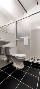 a white bathroom with a toilet and a shower at HOTEL BUGANVILIA in Oiba