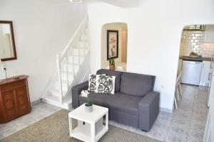 a living room with a couch and a table at LIONS HOUSE PYTHAGORIO in Pythagoreio